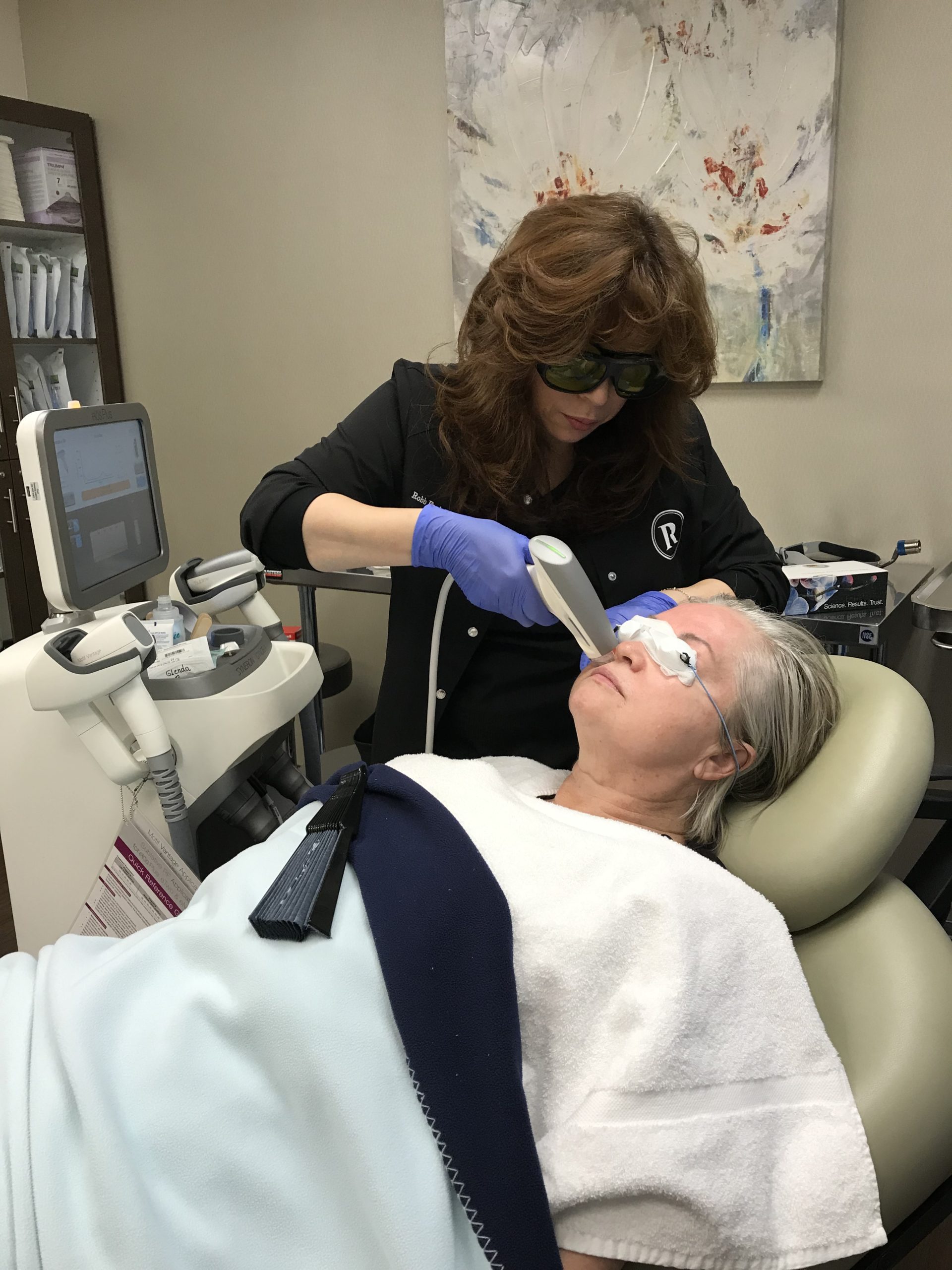 Monica Mogge performing a laser treatment